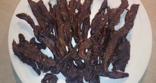 Pictures shows a plate full with a bunch of smoked teriyaki flavored beef jerky